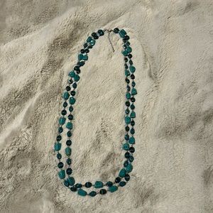 Like new double stranded necklace with turquoise colored stones.